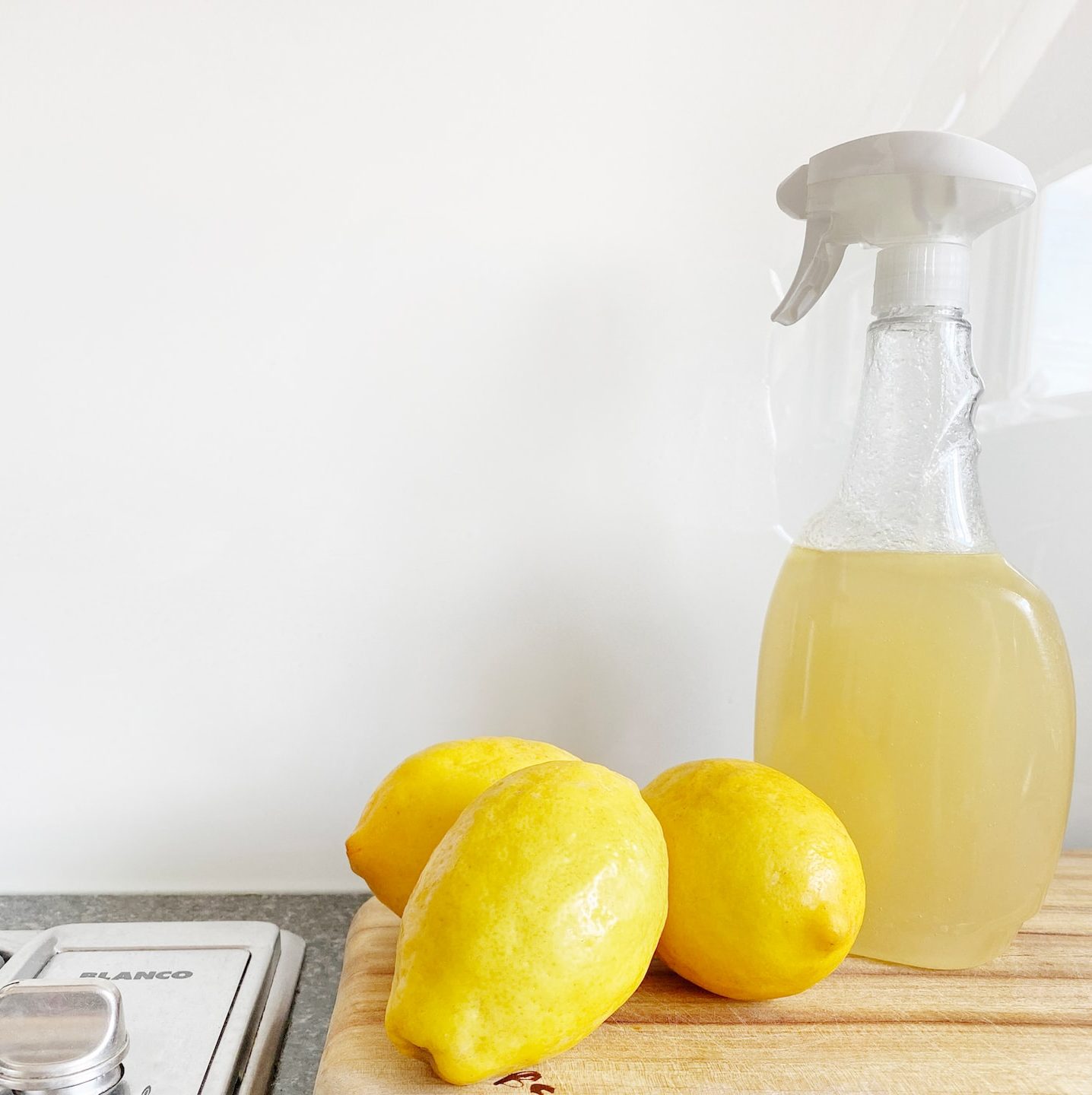 yellow lemon fruit beside clear glass bottle